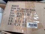 a cardboard box with a package on it sitting on top of a pile of other boxes
