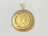 a close up of a gold coin on a white surface