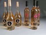 several bottles of wine are lined up in a row on a table