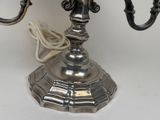 a silver candelab with two candles on it