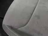 the interior of a car with a paper sticking out of it ' s seat