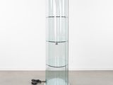 an image of a glass display case with three shelves and a mouse on the floor
