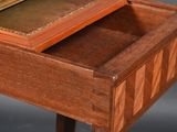 a wooden table with a marble top and a drawer on it