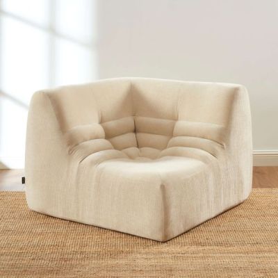 an image of a beige chair sitting on top of a rug
