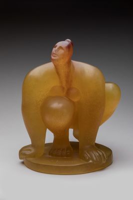 yellow jade figurine of a bird holding a ball