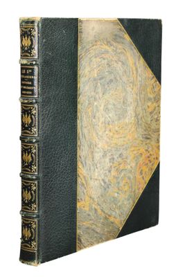an old book with a black cover and gold trim