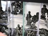 a display case filled with metal figurines of knights