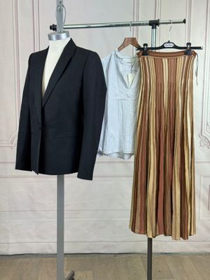 a suit and a skirt on a mannequin stand