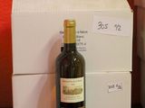 a bottle of wine sitting next to a box on a table