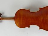 an antique violin with a wooden back and bow on a white background