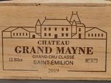 a wooden box with a label on it that says chateau grand mayone