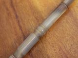 an image of a wooden table with a pen on top of it