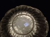 a silver plate with a sticker on it