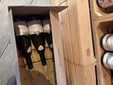 many bottles of wine in a wooden wine rack