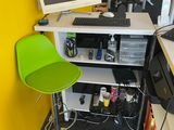a computer desk with a green chair in front of it