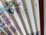 a fan with flowers on it sitting on a table
