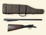 an old gun with a leather case and a wooden handle