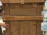 a man that is standing next to a piece of wood