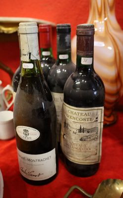 several bottles of wine are lined up on a red table cloth