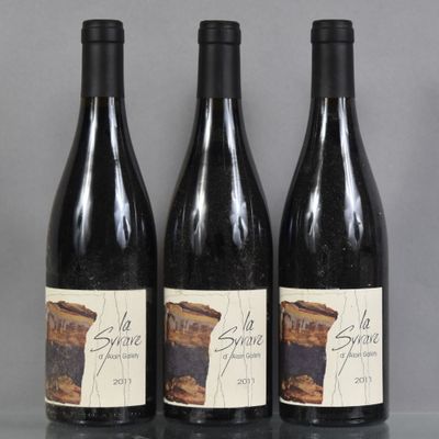 three bottles of wine sitting on top of a table next to each other