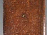 an old brown leather book sitting on top of a white table