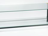 a glass coffee table with a metal base and a glass shelf