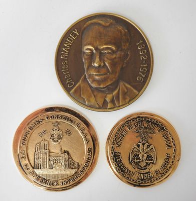 two commemorative coins with a picture of a man and a building