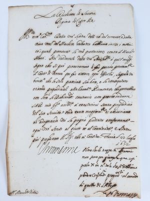 a piece of paper with handwriting on it sitting on top of a table