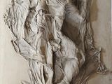 a sculpture of a woman on a horse on a wall