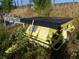 a yellow truck that is sitting in the grass