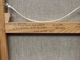 a picture of a wooden frame with writing on it