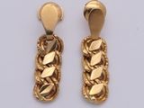 two pairs of gold earrings with leaves on them on a white surface