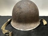an old helmet is sitting on top of a black cloth