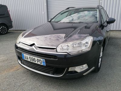 a black citrole parked in front of a building