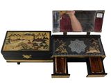 a black and gold box with a mirror on top of it