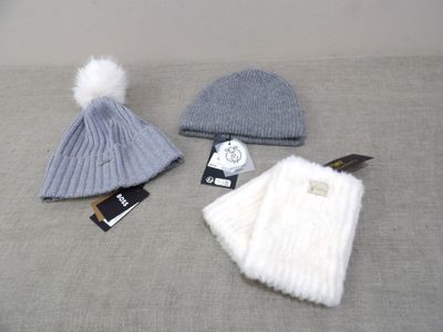 three hats are sitting on a bed with tags on them