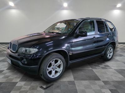 a picture of a black bmw suv parked in a garage
