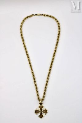 a gold necklace with a cross pendant on a chain