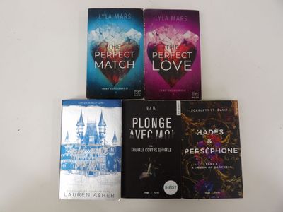 four books on a white table with a white background