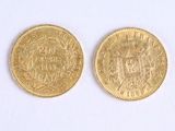 two pieces of gold coins with a picture of a man and a woman on them