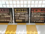three framed posters on a window sill in front of a window