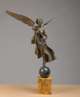 a bronze statue of an angel on a marble base