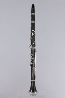 a black and silver clarinet on a clear surface