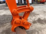 a close up of an orange machine on the ground