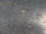 an antique silver plate with the name of a person on it