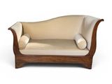 an image of a wooden couch with a beige upholstered cushion