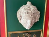 a picture of a plaque with a lion head on it