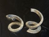 pair of silver horseshoes sitting on a black cloth