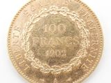 a gold coin with a wreath on it on a white surface