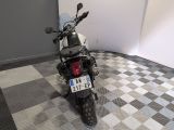 a motorcycle that is parked in a room with a checkered floor